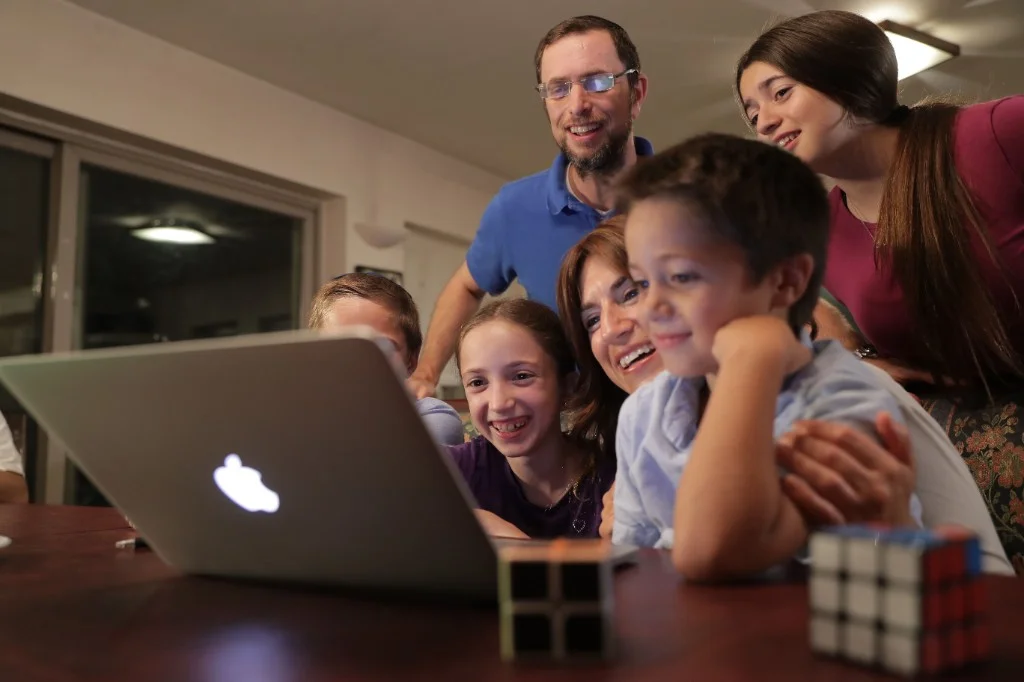 A Jewish family watching Torah Live together at home